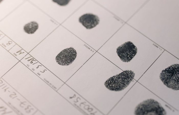 Detailed fingerprints on official document, highlighting identity verification process.