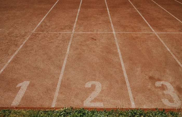 Outdoor sports track with lanes numbered 1 to 3, ready for an athletic event.