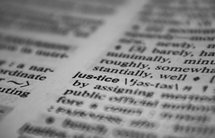 Selective focus close-up of the word justice in a dictionary, emphasizing concept clarity.